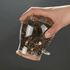 Glass storage jar with fitted bamboo lid held upside down