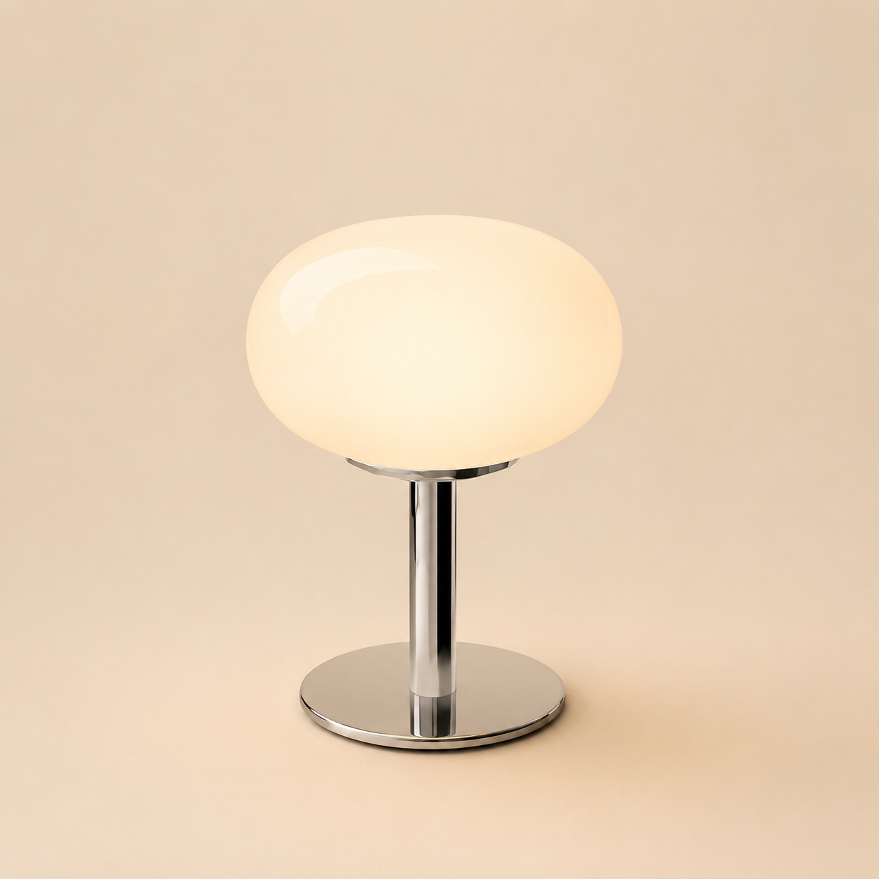 White oval glass table lamp isolated on a warm beige background.