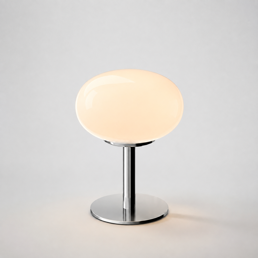 Pale pink oval glass table lamp isolated on a light gray background.