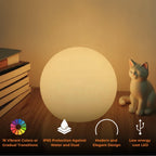 Globe table lamp displayed in a home setting with colored light.