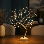 Tree of Light table lamp glowing on a dark console in a teal living room.