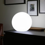 LED moon lamp illuminating an evening setting.