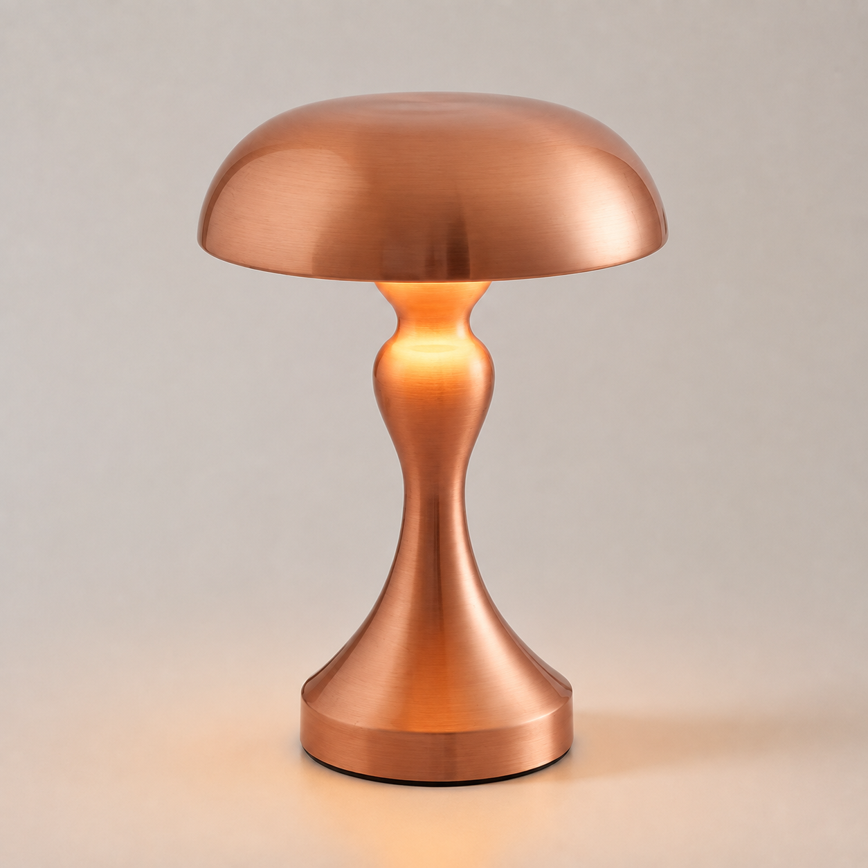Copper table lamp glowing against a light gray background.
