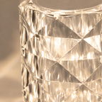 Close-up of the table lamp’s clear faceted surface reflecting warm light.