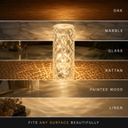Glowing faceted table lamp displayed across oak, marble, glass, rattan, painted wood, and linen surfaces.