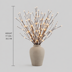 A lighted branch vase is centered in a dimensions graphic with vertical and horizontal measurement lines.