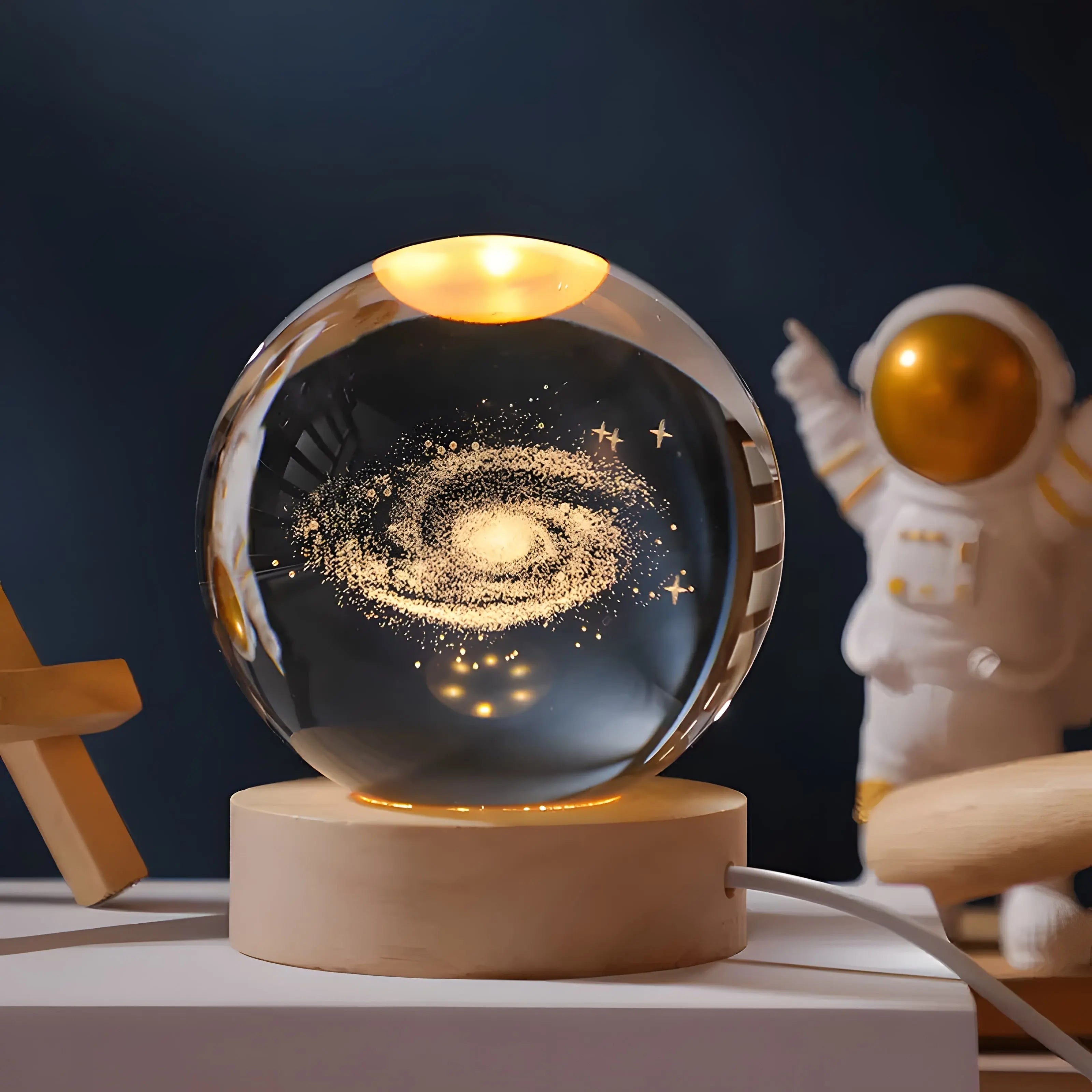 Crystal sphere table lamp with galaxy engraving on a wooden light base