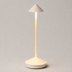 White cordless table lamp with a slim stem and conical shade, illuminated against a light gray background.