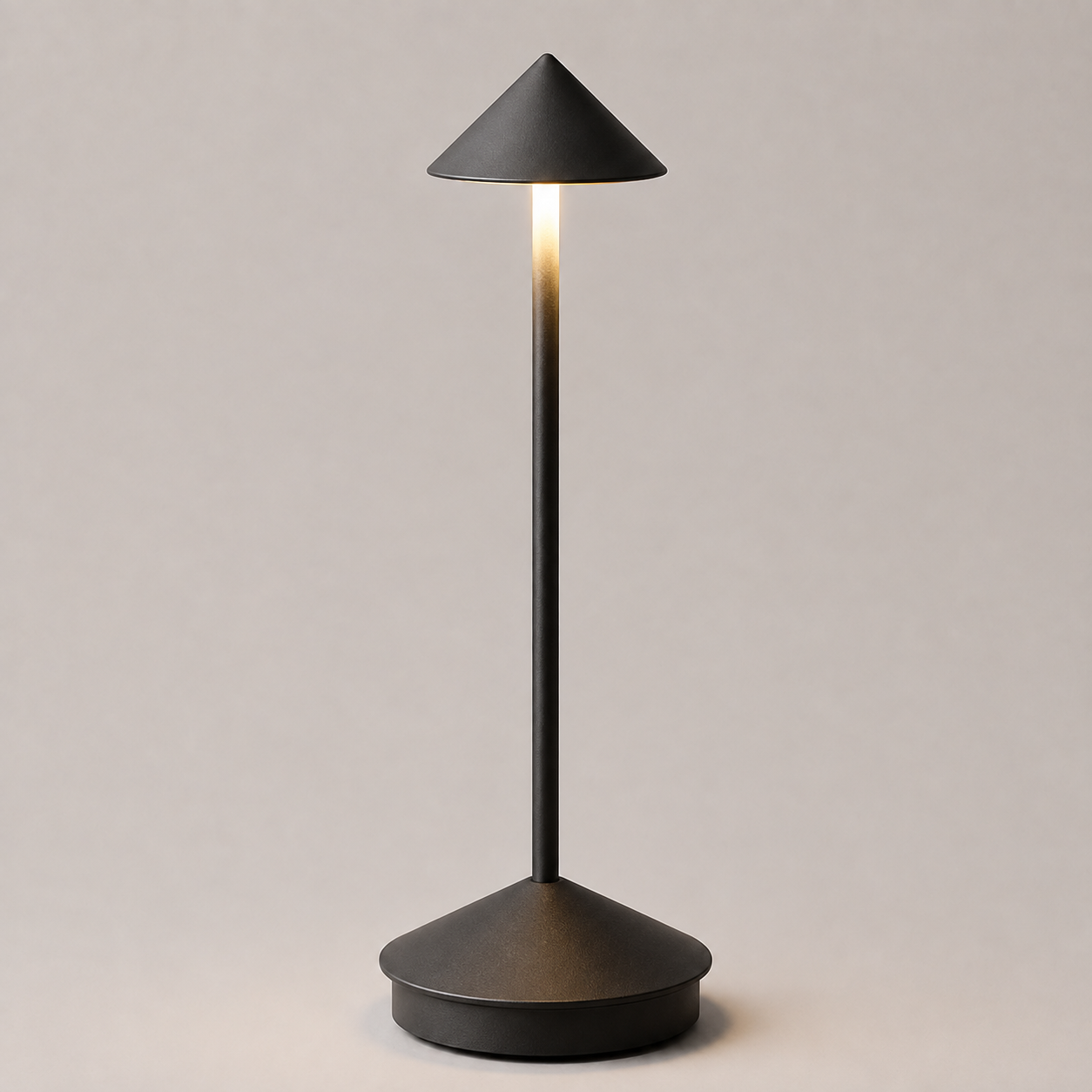 Black cordless table lamp with a conical shade, illuminated against a neutral background.