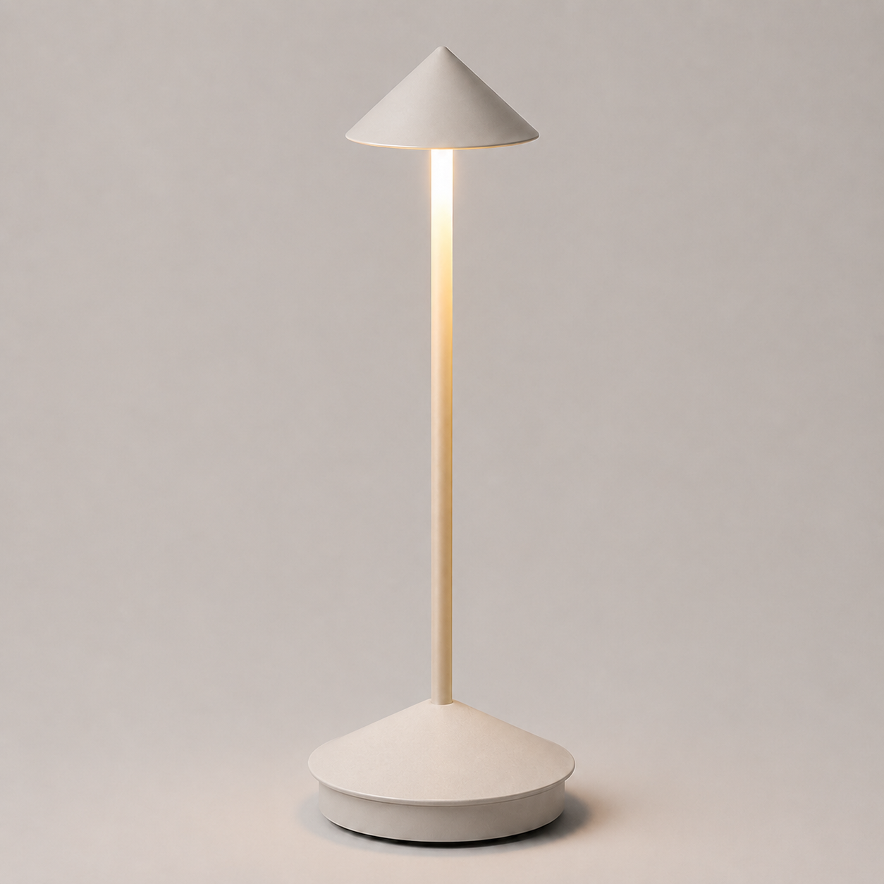 Gray cordless table lamp with a conical shade, illuminated against a neutral background.