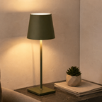 green rechargeable table lamp displayed with a small plant