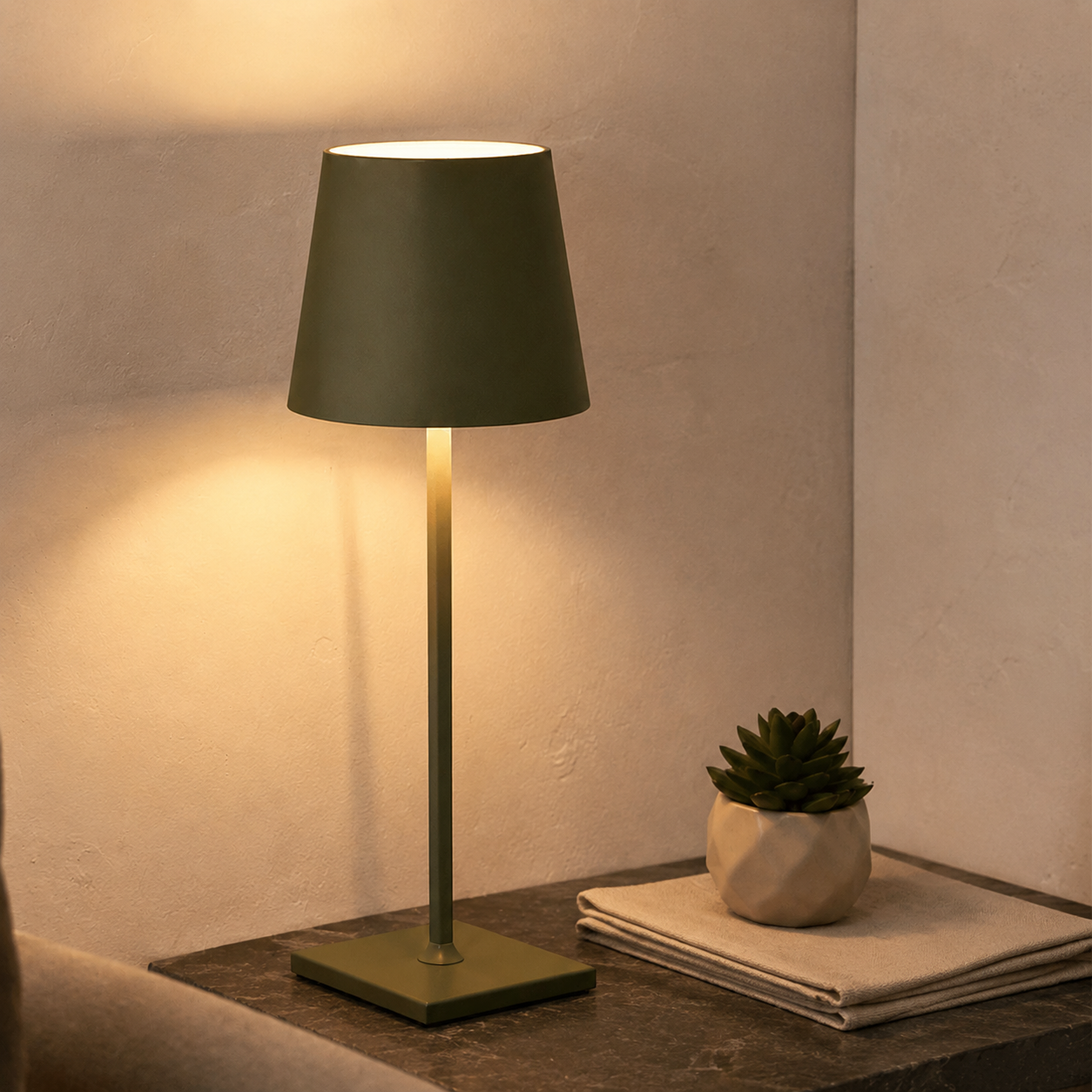 green rechargeable table lamp displayed with a small plant