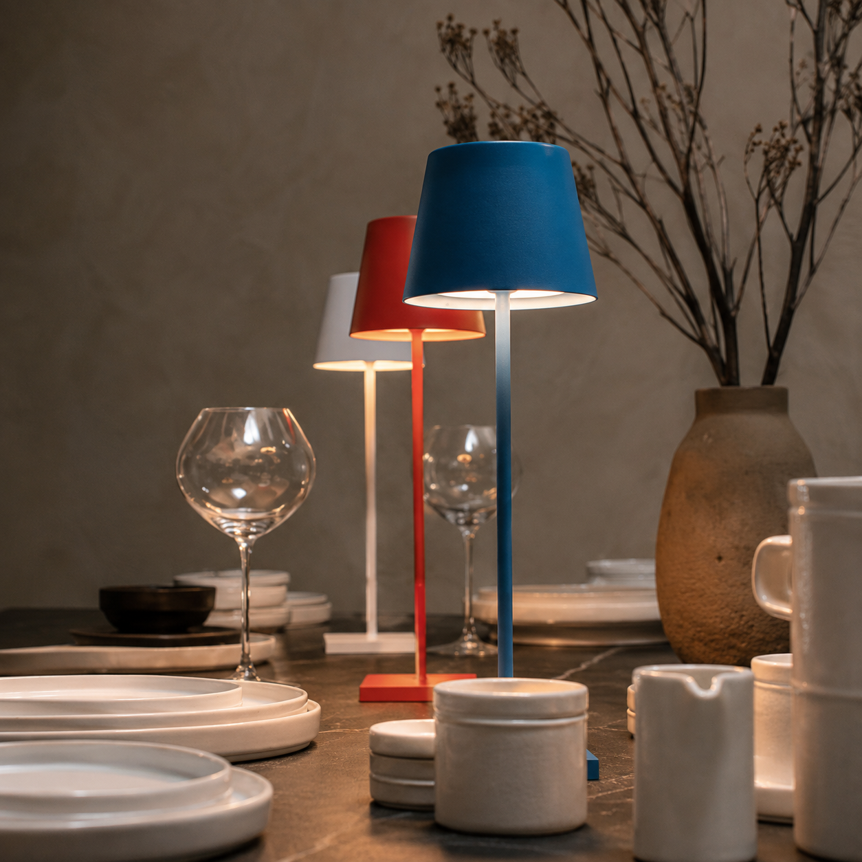 red and blue rechargeable table lamps grouped on a styled dining table