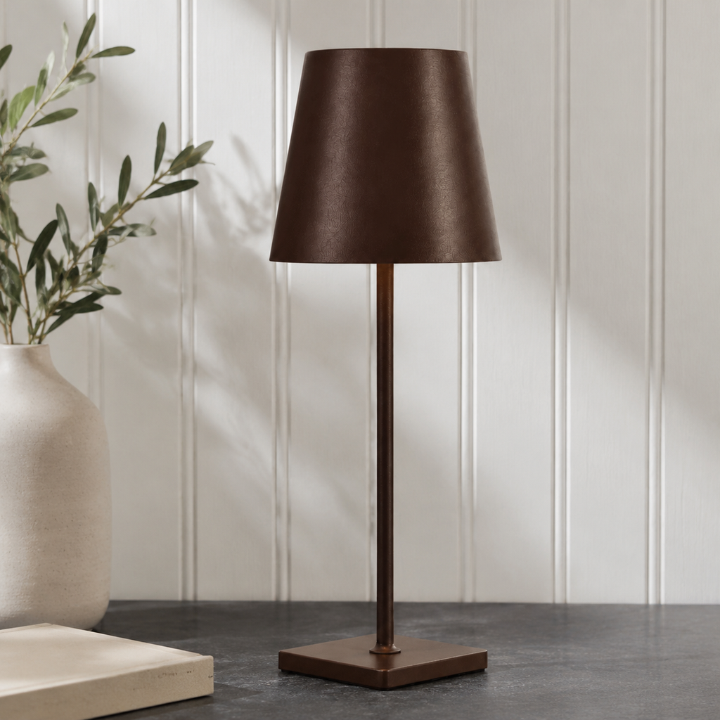 brown rechargeable table lamp standing on a dark stone counter