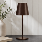 brown rechargeable table lamp standing on a dark stone counter