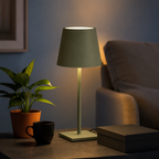 green rechargeable table lamp glowing beside an armchair