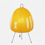 Table lamp with a yellow patterned shade isolated on white.