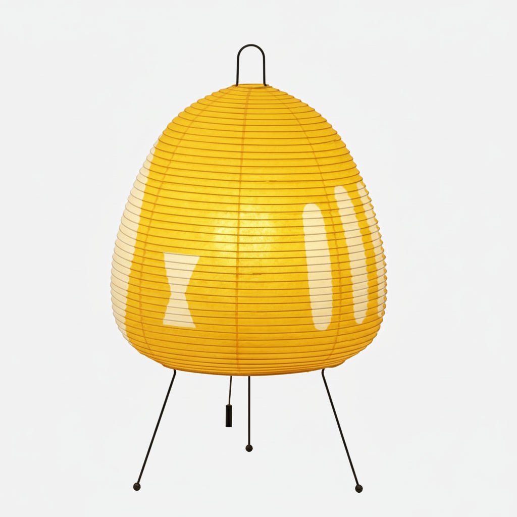 Table lamp with a yellow patterned shade isolated on white.