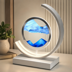 Blue quicksand table lamp with a white frame displayed on a bright desk.