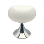 White donut table lamp with a polished metal pedestal on a plain background.