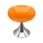 Orange donut table lamp with a rounded glass shade and metal pedestal.