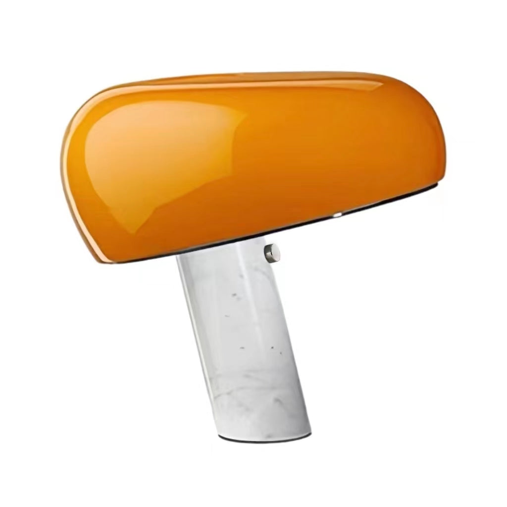 Orange table lamp with a broad glossy shade and white marble base.