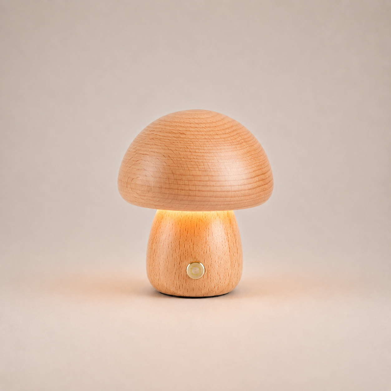 Table lamp with a wide amber mushroom shade and short rounded base on a light beige studio background.