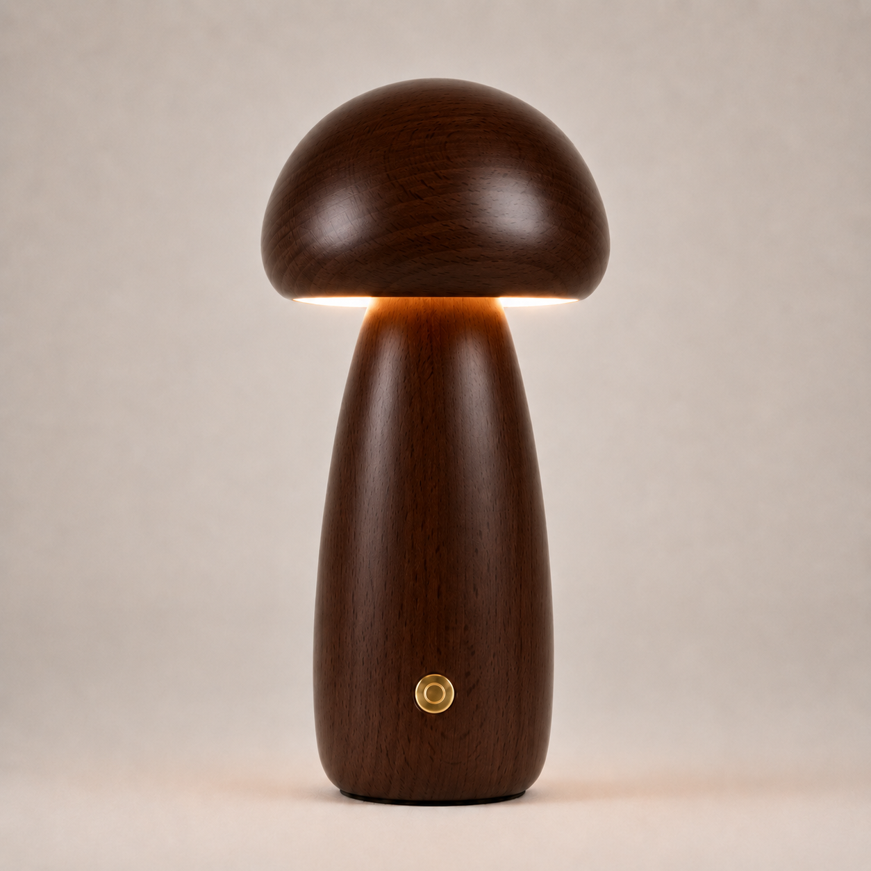 Dark brown mushroom table lamp with a tall rounded base, gold button, and warm light on a beige background.