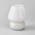 White swirled glass table lamp shown unlit on a light gray background.