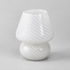 White swirled glass table lamp shown unlit on a light gray background.