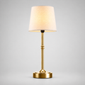 Gold cordless table lamp with a tapered white shade centered on a plain background.
