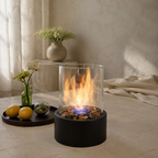 black tabletop fireplace glowing on a dining table with two glasses