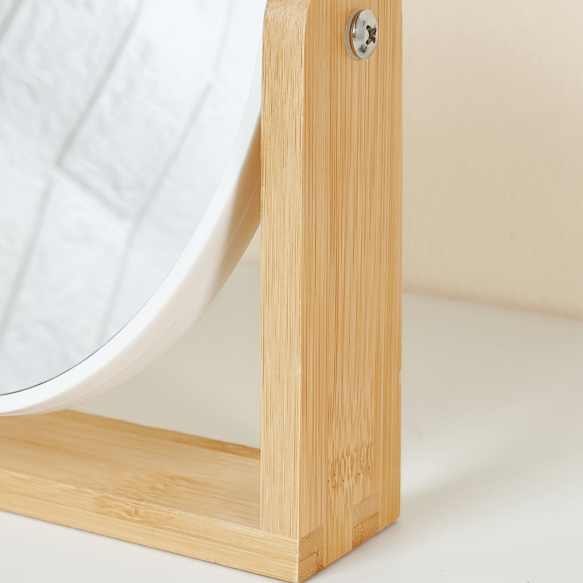 Double sided bamboo makeup mirror viewed from the side