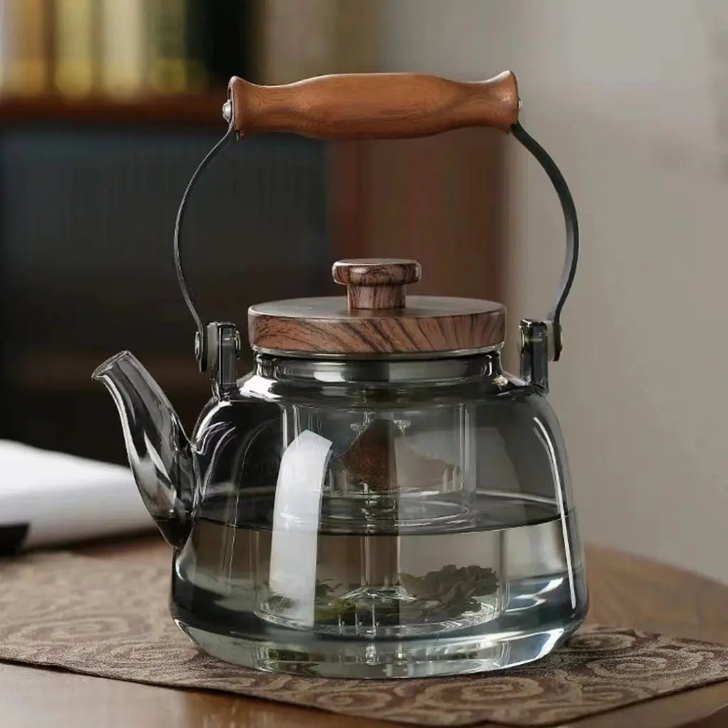 Smooth smoky glass teapot with arched wooden carry handle