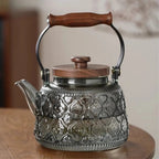 Patterned smoky gray glass teapot with wooden carry grip