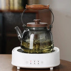 Smooth smoky glass teapot with arched wooden carry handle