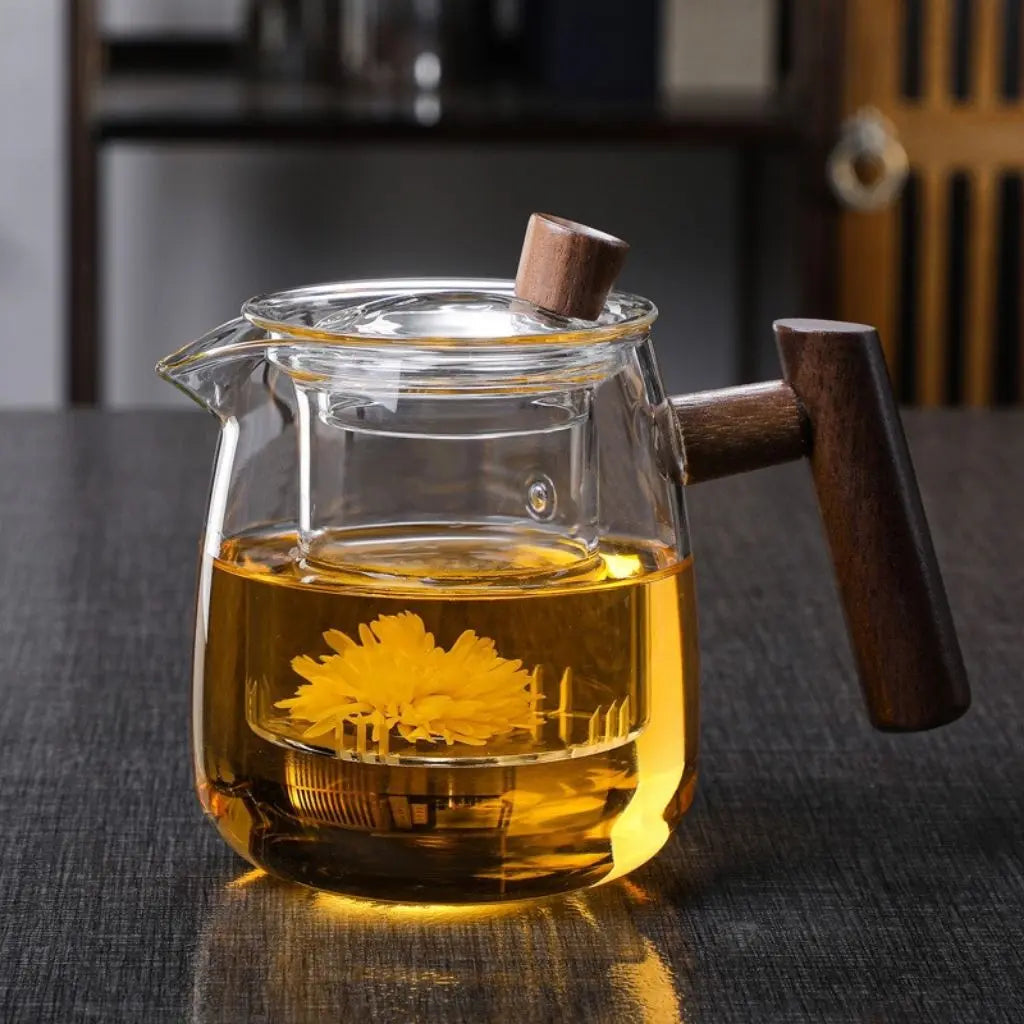 Clear borosilicate glass teapot with solid wood handle and tea inside