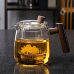 Clear borosilicate glass teapot with solid wood handle and tea inside