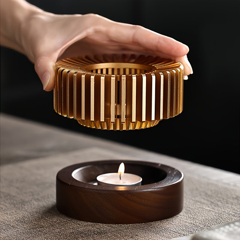Hand lifting the slatted metal top above a lit tealight in the base.