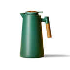 Thermal coffee carafe in a tabletop coffee serving scene.