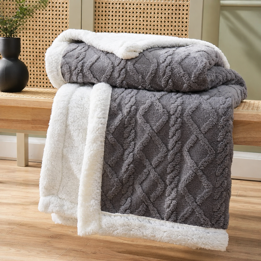 Sherpa fleece throw blanket folded in charcoal with thick white plush lining