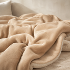 pink sherpa throw blanket folded back to show the cream reverse
