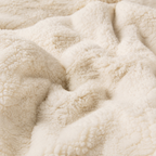 close-up of beige sherpa throw blanket fleece and plush lining