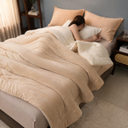 beige sherpa throw blanket covering a resting person with face hidden