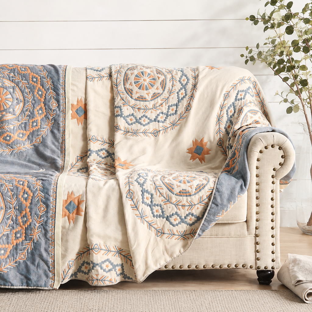 woven mandala throw blanket draped over a light upholstered armchair