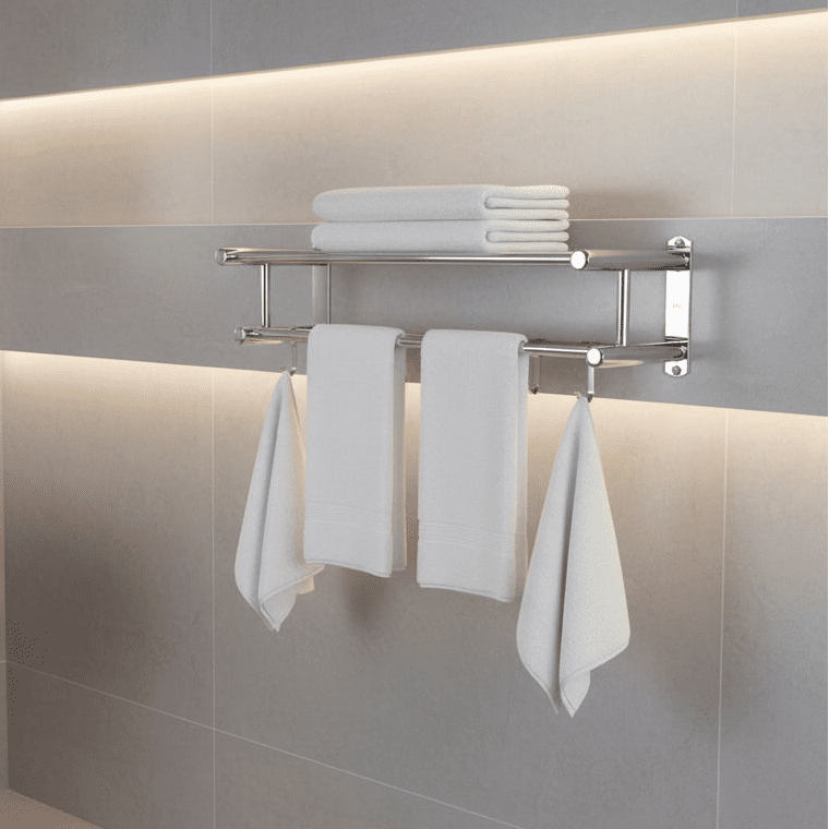 Towel rack in matte silver mounted on a tiled wall with folded and hanging white towels.