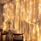Warm White curtain fairy lights glowing across sheer window curtains.