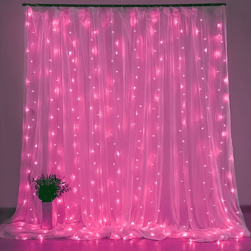 Fairy curtain lights glow pink behind a small flower arrangement.