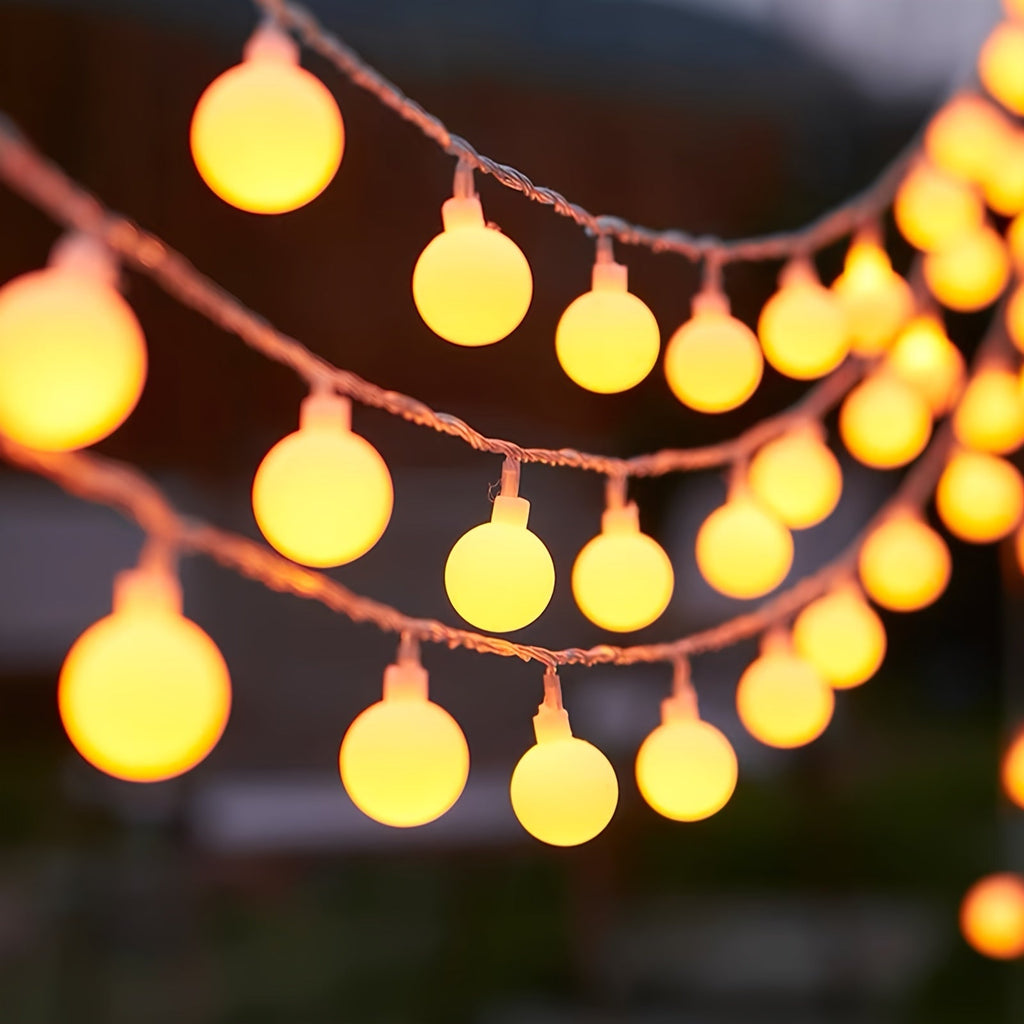 Globe fairy lights show warm glowing globes along parallel strings.