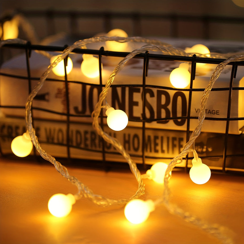 Globe fairy lights glow beside a wire book basket.